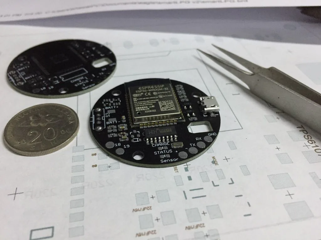 Compact round custom PCB with ESP32-WROOM-32 module, micro-USB and labelled battery and sensor connections