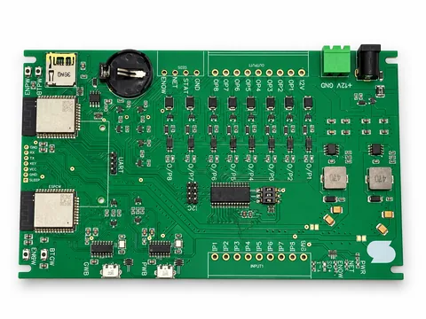 Green eight-channel I/O controller PCB with two wireless modules, input and output pads, USB connectors and battery holder
