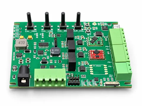 Green sensor interface PCB with four calibration controls, green terminal blocks and red and green daughterboards